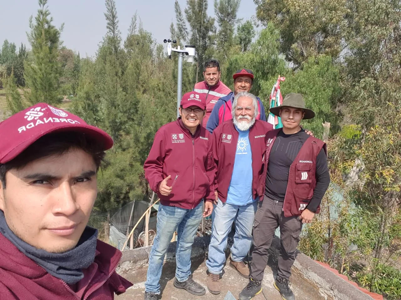 Field deployment crew installing a WeatherXM weather station for forest microclimate monitoring